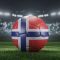 Soccer ball in flag colors on a bright blurred stadium background. Norway. 3D image
